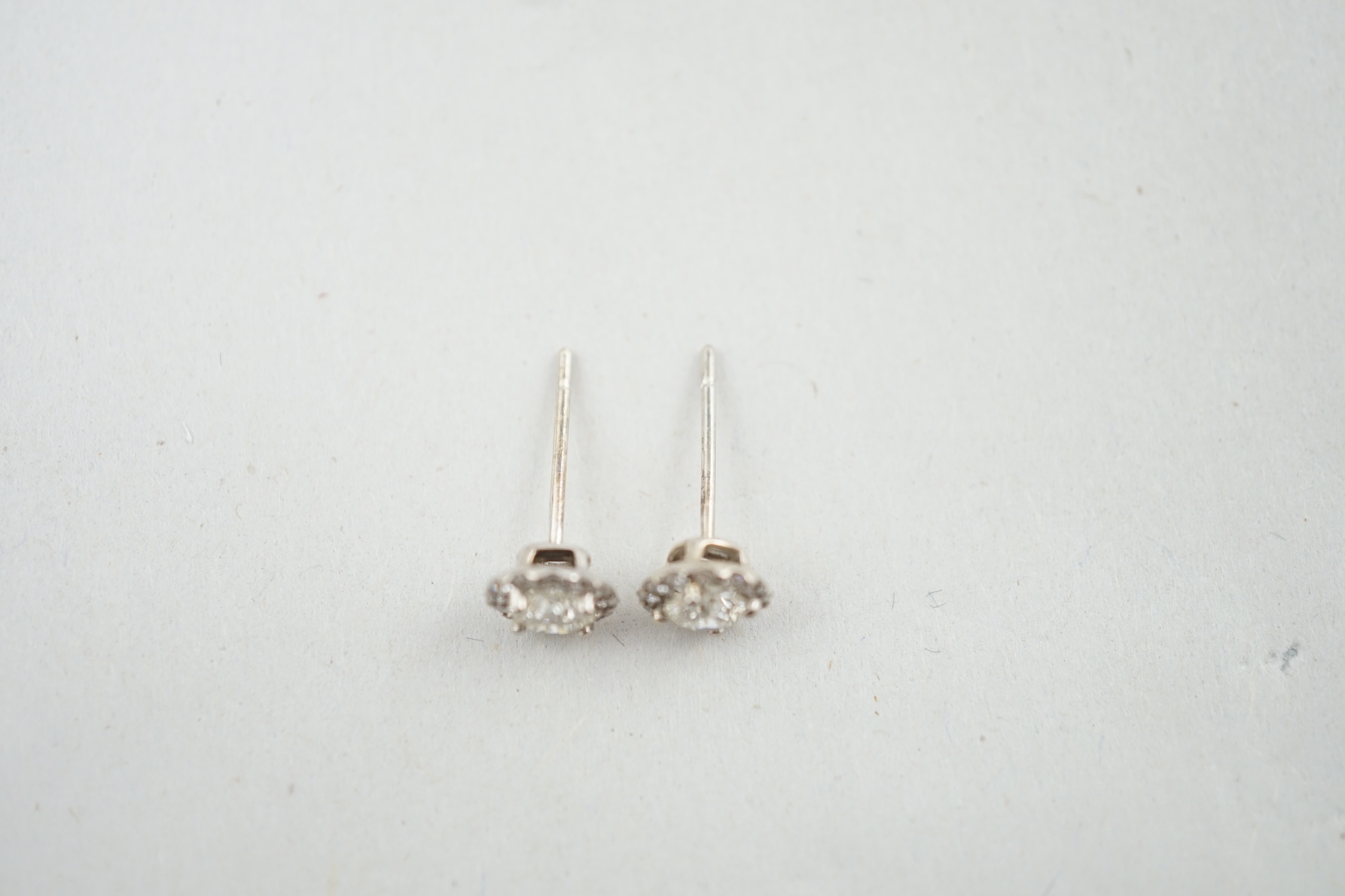 A modern pair of 18ct white gold and diamond cluster set ear studs